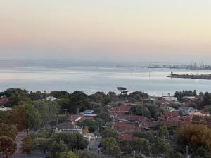 an aerial view of a city and the water at Complete Host Nine Elm Apartments in Melbourne