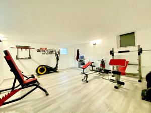 a gym with treadmills and exercise equipment in a room at Apartments Green Paradise in Bohinj