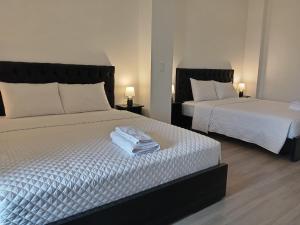 a bedroom with two beds with towels on them at Finca Procel in Palora