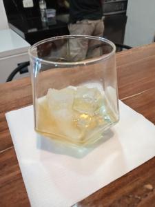 a glass filled with ice on a wooden table at Finca Procel in Palora