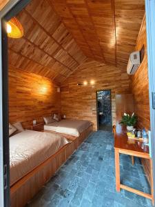 a bedroom with two beds and a desk in a room at Ninh Binh Mountainside Bungalow in Ninh Binh +33 photos