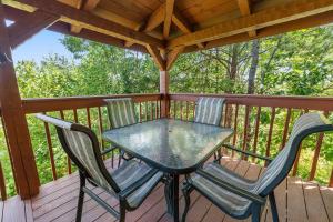 a table and two chairs on a deck at Sweet Scarlet Rose cabin in Sevierville