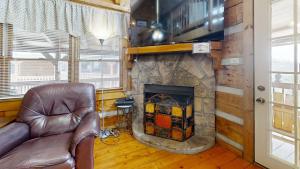 a living room with a couch and a fireplace at Sweet Scarlet Rose cabin in Sevierville