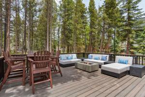 a deck with chairs and a couch and a table at Apres Ski Haven Pet Friendly with Private Hot tub in Breckenridge