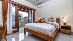 Postel nebo postele na pokoji v ubytování Depi House Ubud