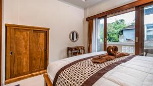 Postel nebo postele na pokoji v ubytování Depi House Ubud