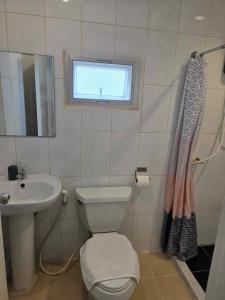 a bathroom with a toilet and a sink and a window at City Inn Udonthani in Udon Thani +64 photos