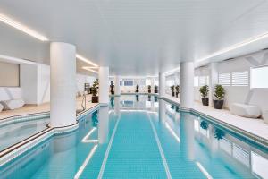 a large swimming pool in a building at Meriton Suites Bondi Junction in Sydney