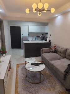 a living room with a couch and a table at Sanctum comfy Homes at Kindaruma in Nairobi
