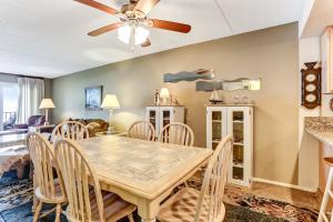 a dining room and living room with a table and chairs at Fresh Oceanfront Condo in Fernandina Beach