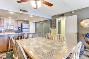 a kitchen and dining room with a table and chairs at Fresh Oceanfront Condo in Fernandina Beach
