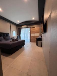 een grote slaapkamer met een bed en een televisie bij Cloud9 Reloaded in Pattaya