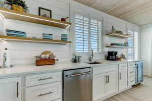 a kitchen with white cabinets and stainless steel appliances at 226 South Fletcher Ave home in Fernandina Beach