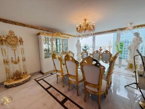 Un comedor con una mesa y sillas y una lámpara de araña. en El Palacio del Rey, en Lima