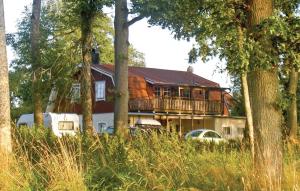 a house with a balcony in the middle of trees at Stunning Home In Ljungby With Wifi in Bolmstad