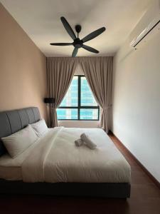 a bedroom with a bed with a ceiling fan at Shah Alam Homestay 4BDR by StayScape in Shah Alam