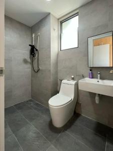 a bathroom with a toilet and a sink at Shah Alam Homestay 4BDR by StayScape in Shah Alam
