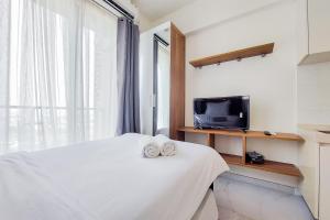 Postel nebo postele na pokoji v ubytování Comfort Stay Studio at Sky House BSD Apartment By Travelio + 11 fotografií