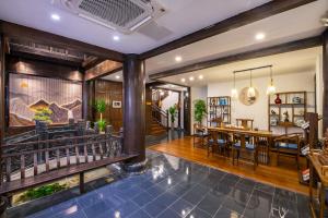 a dining room and living room with a dining table at Huangshan Chuyuyuan Manju Homestay in Huangshan