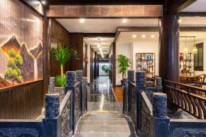 a corridor of a restaurant with blue chairs at Huangshan Chuyuyuan Manju Homestay in Huangshan