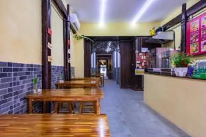 a row of wooden tables and benches in a restaurant at Huangshan Chuyuyuan Manju Homestay in Huangshan