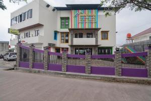 a purple fence in front of a building at Mamifokobo Hotel & Glamping in Sindanglaya +115 photos