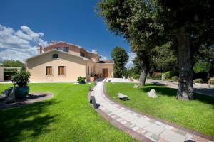 a house with a tree and a grass yard at Villa Rosa Magica - Happy Rentals in Labin