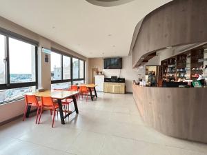 a restaurant with tables and chairs and a counter at Matsu Star Yang Homestay in Beigan