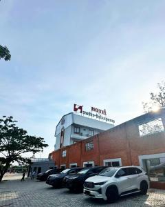 a white car parked in a parking lot in front of a hotel at Swiss-Belexpress Rest Area KM 260B in Bulakamba