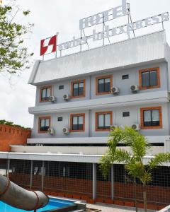 a hotel building with a swimming pool in front of it at Swiss-Belexpress Rest Area KM 260B in Bulakamba
