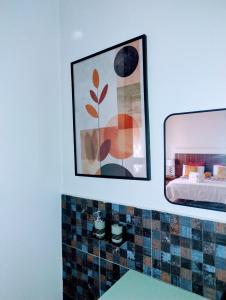 a bathroom with a mirror and a bed at Bethel apartments ug in Kampala