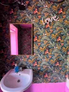 a bathroom with a pink mirror and a sink at Casa Barbie Costinesti in Costinesti