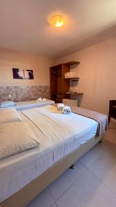 a bedroom with a large white bed in a room at Hotel Italia Beach - Na Beira Mar Natal RN in Natal +39 photos