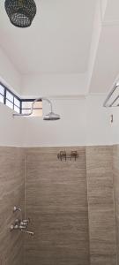 a bathroom with a shower with a shower head at A La Maison in Shillong +48 photos