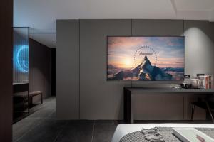 a tv hanging on a wall in a room at ENJI S Shancheng Designer Hotel in Chongqing