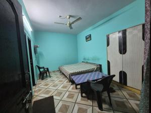 a room with a bed and a table in it at MEHTA Guest House in Rāmpur