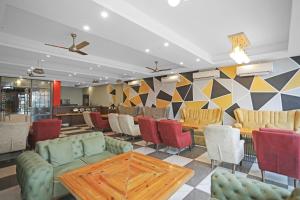 a restaurant with chairs and a table in a room at Hotel O Heart Beat Hotel in Noida