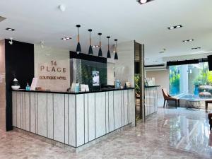 a restaurant with a counter in a lobby at 14 Place in Bangkok