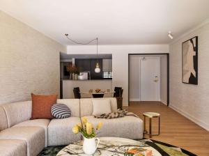 a living room with a couch and a table at Adina Apartment Hotel Sydney Town Hall in Sydney