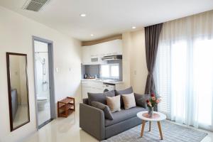 a living room with a couch and a table at 8B Aparthotel in Ho Chi Minh City