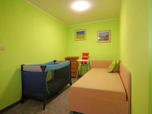 a green room with a couch and a chair at Ferien unterm Reetdach bis zu 6 Personen in Alt Bukow