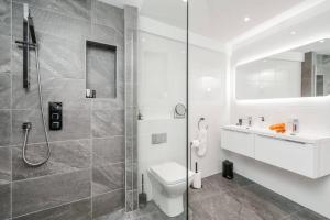 a bathroom with a shower and a toilet and a sink at Brighton Apt - 2 Bedroom Free Wi-Fi & Parking in Wallasey