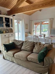 a living room with a couch and a dining room at Maison de charme - piscine - coeur du Périgord ! in Saint-Georges-de-Blancaneix