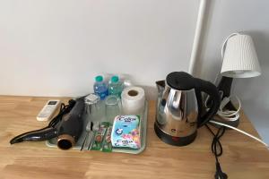 a table with a coffee maker and a blender at XX GO INN BTS Ari - BTS Ari Station in Sathani Sam Sen