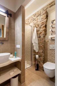 a bathroom with a toilet sink and a shower at Casa Paolina in Viareggio