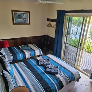Postel nebo postele na pokoji v ubytování Daintree Riverview Lodges