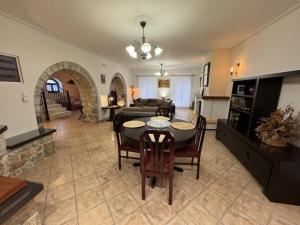 a kitchen and living room with a table and chairs at Villa Iris in Mystras