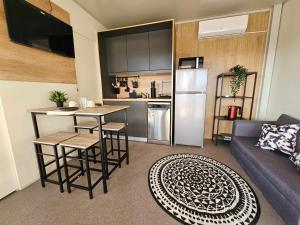 a living room with a couch and a kitchen at Mobile home Tortuga in Drage