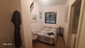 a small bedroom with a bed and a window at Sitges BnB Superior Rooms in Sitges +28 photos