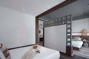Xishuangbanna Verdant House Resort Hotel 객실 침대